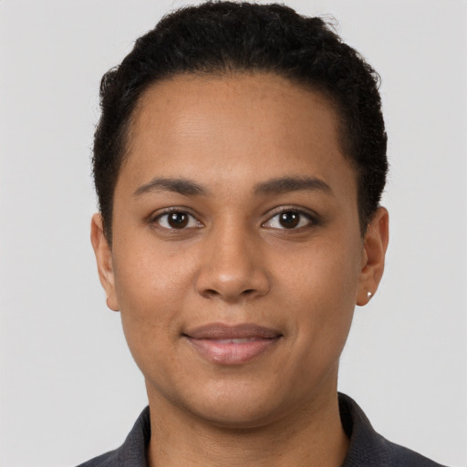 Joyful latino young-adult female with short  brown hair and brown eyes
