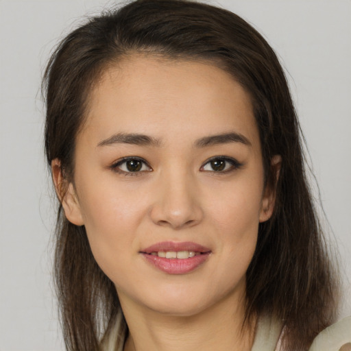 Joyful latino young-adult female with medium  brown hair and brown eyes
