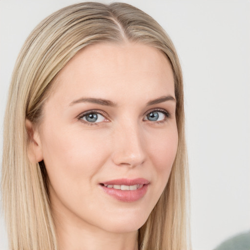 Joyful white young-adult female with long  brown hair and blue eyes