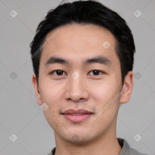 Joyful asian young-adult male with short  black hair and brown eyes