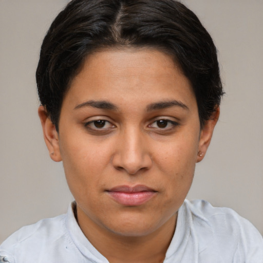 Joyful latino young-adult female with short  brown hair and brown eyes