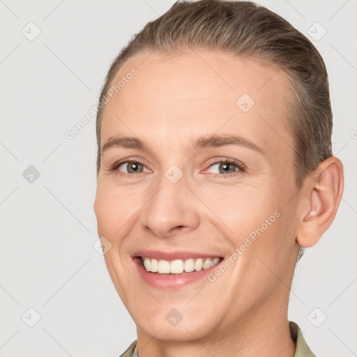 Joyful white adult female with short  brown hair and brown eyes