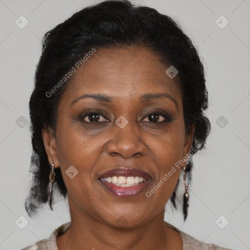 Joyful black adult female with medium  brown hair and brown eyes