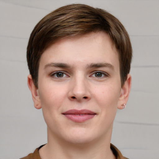 Joyful white young-adult female with short  brown hair and grey eyes