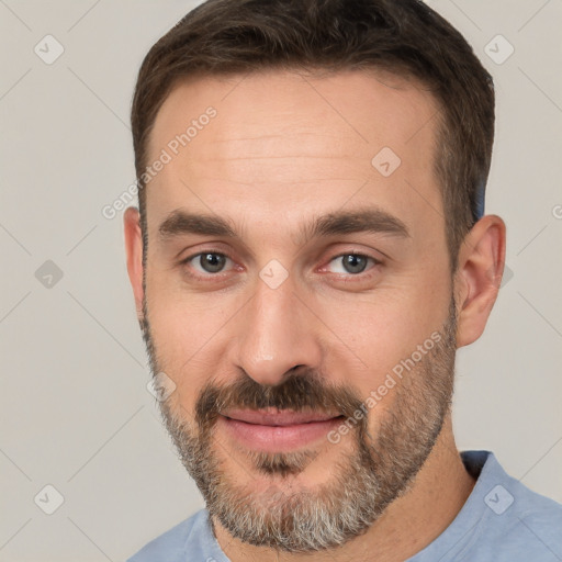 Joyful white adult male with short  brown hair and brown eyes