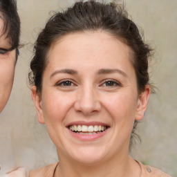 Joyful white adult female with medium  brown hair and brown eyes