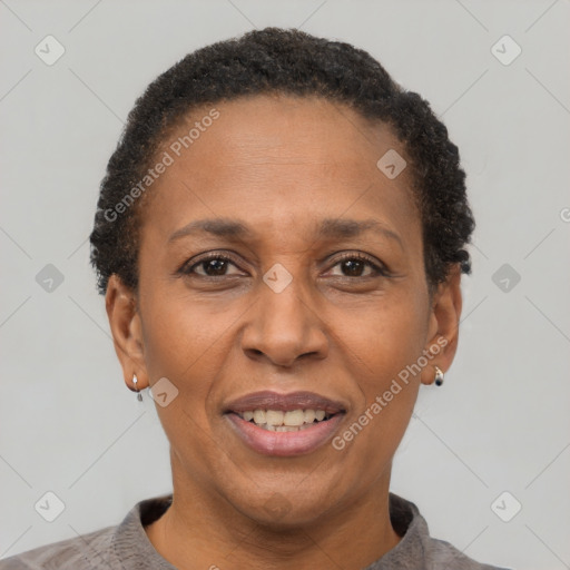 Joyful black adult female with short  brown hair and brown eyes