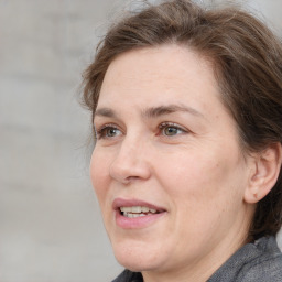 Joyful white adult female with medium  brown hair and grey eyes