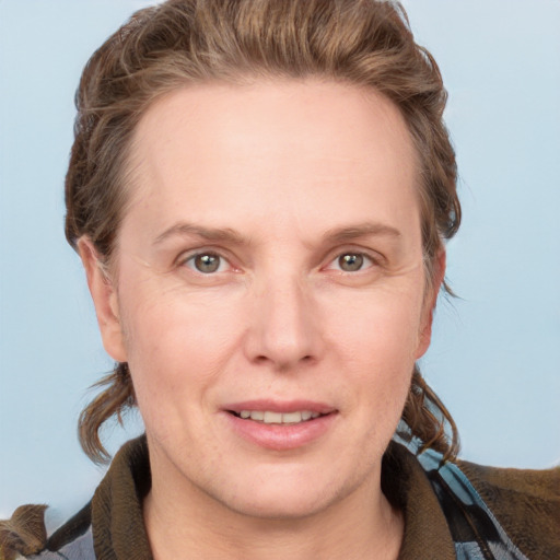 Joyful white adult female with medium  brown hair and grey eyes