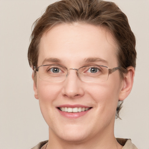 Joyful white adult female with short  brown hair and grey eyes