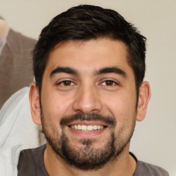 Joyful white young-adult male with short  black hair and brown eyes