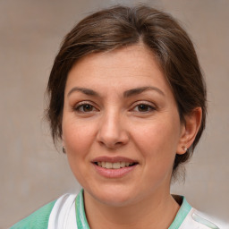 Joyful white adult female with medium  brown hair and brown eyes