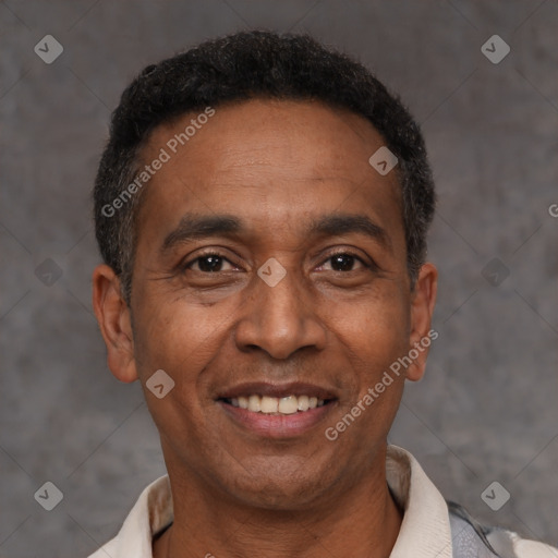 Joyful latino adult male with short  black hair and brown eyes