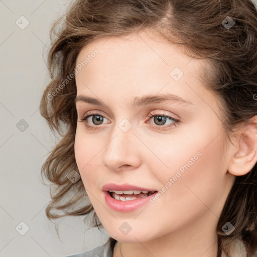 Joyful white young-adult female with medium  brown hair and blue eyes