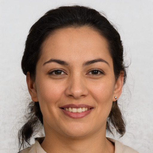 Joyful white young-adult female with medium  brown hair and brown eyes