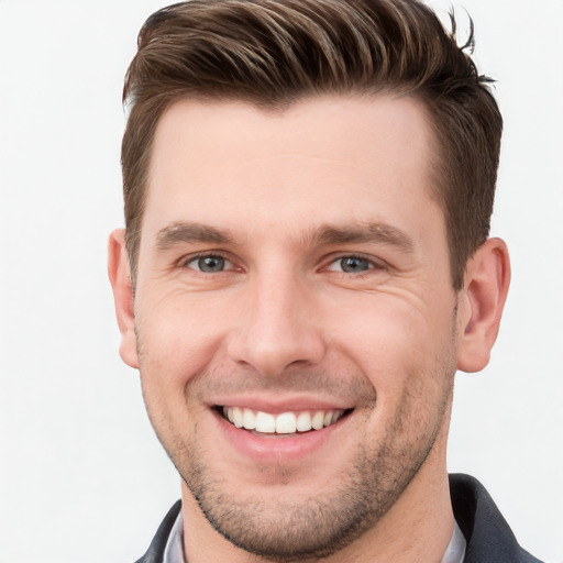 Joyful white young-adult male with short  brown hair and grey eyes