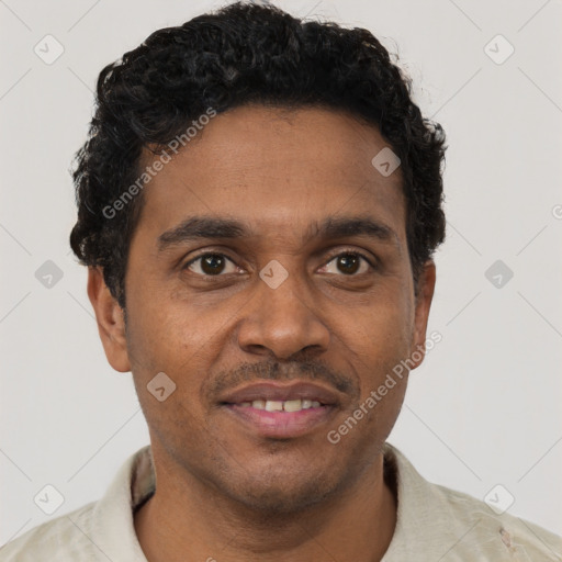 Joyful black young-adult male with short  brown hair and brown eyes