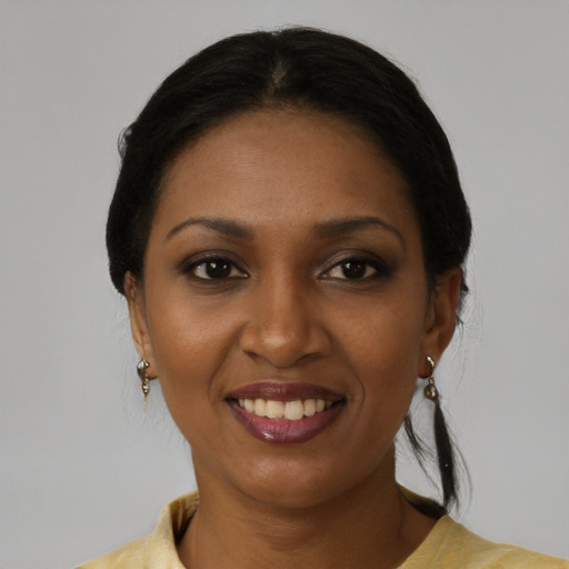 Joyful black young-adult female with medium  black hair and brown eyes