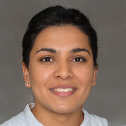 Joyful latino young-adult female with short  brown hair and brown eyes