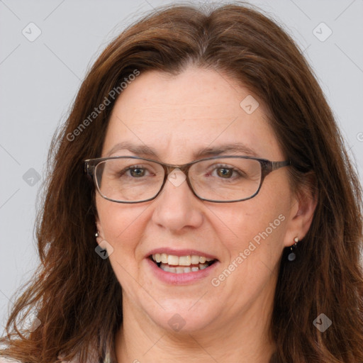 Joyful white adult female with long  brown hair and grey eyes