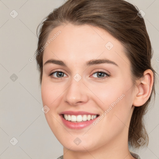 Joyful white young-adult female with medium  brown hair and green eyes