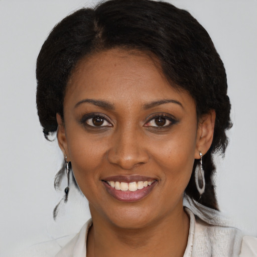 Joyful black young-adult female with medium  brown hair and brown eyes