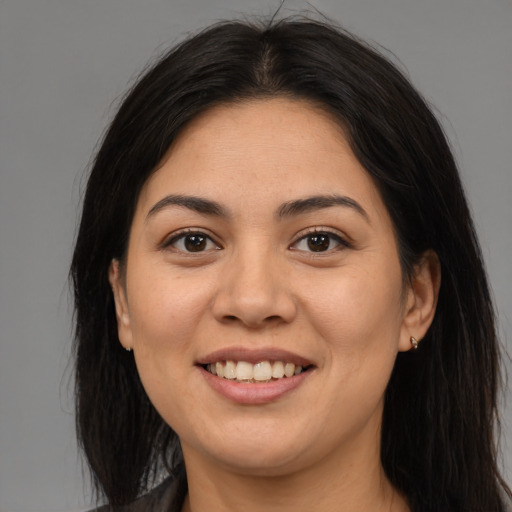 Joyful latino young-adult female with long  brown hair and brown eyes