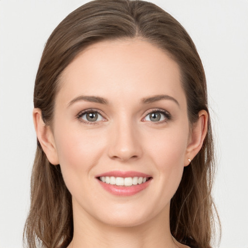 Joyful white young-adult female with long  brown hair and grey eyes