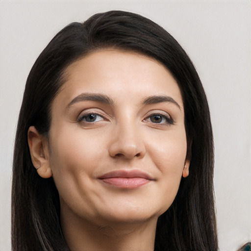 Joyful latino young-adult female with long  black hair and brown eyes