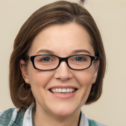 Joyful white young-adult female with medium  brown hair and blue eyes