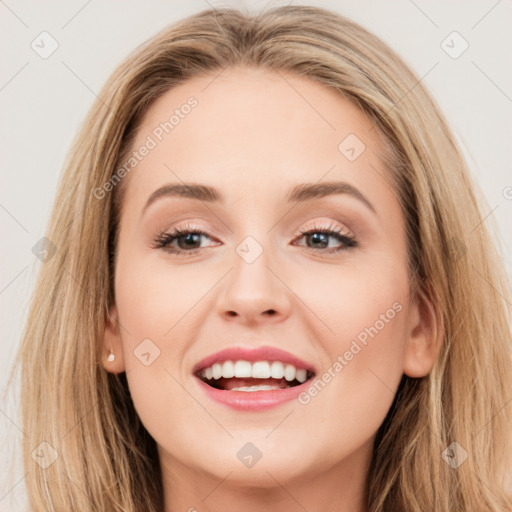 Joyful white young-adult female with long  brown hair and blue eyes