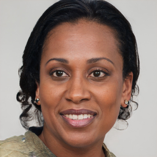 Joyful black adult female with medium  brown hair and brown eyes