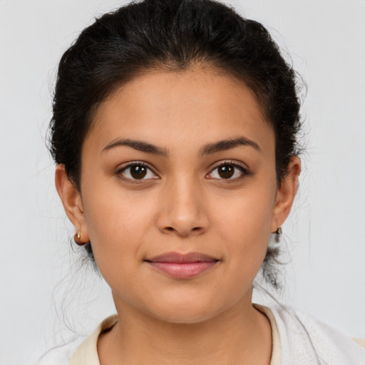 Joyful latino young-adult female with medium  brown hair and brown eyes