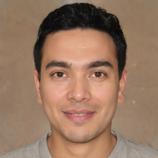 Joyful asian young-adult male with short  black hair and brown eyes