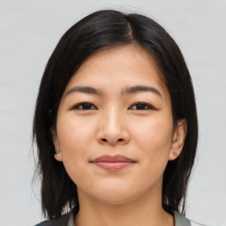 Joyful asian young-adult female with medium  black hair and brown eyes