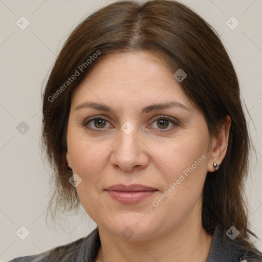 Joyful white adult female with medium  brown hair and grey eyes