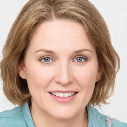 Joyful white young-adult female with medium  brown hair and blue eyes