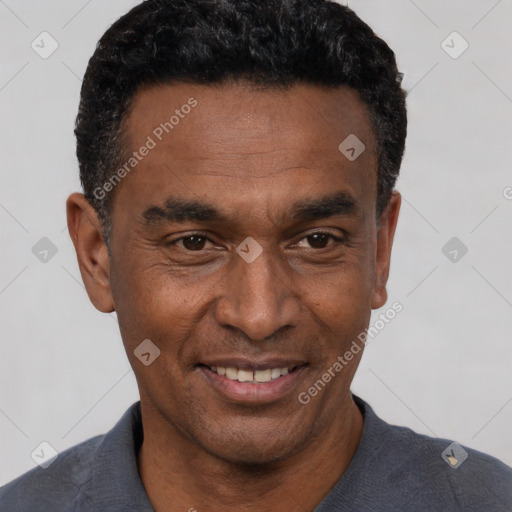 Joyful black adult male with short  black hair and brown eyes