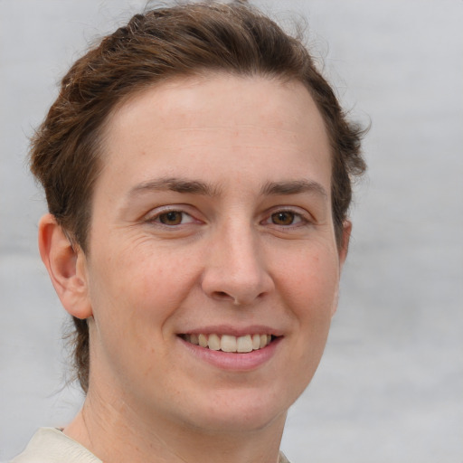 Joyful white young-adult female with short  brown hair and grey eyes