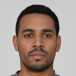Neutral latino young-adult male with short  black hair and brown eyes