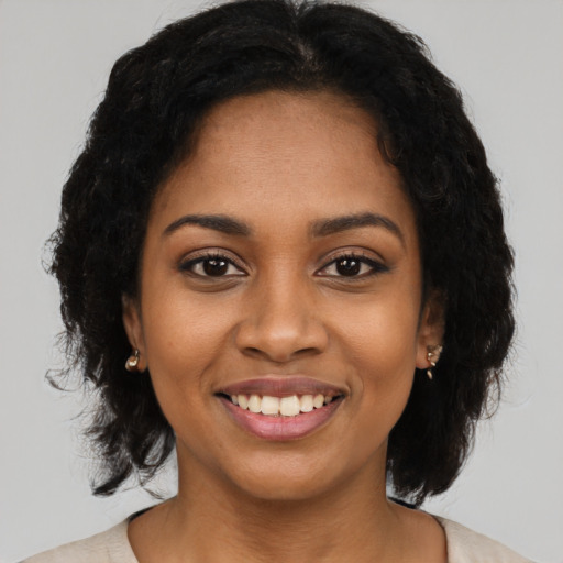 Joyful black young-adult female with medium  black hair and brown eyes