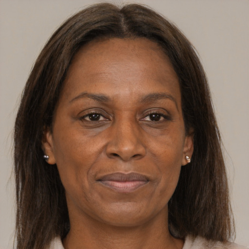 Joyful black adult female with medium  brown hair and brown eyes