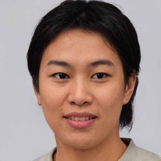 Joyful asian young-adult female with medium  black hair and brown eyes