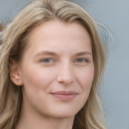Joyful white young-adult female with long  brown hair and blue eyes
