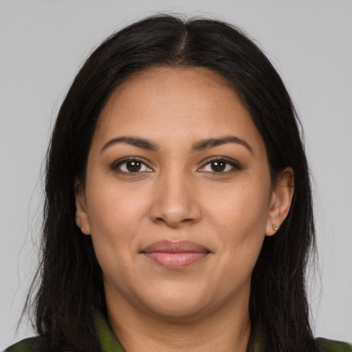 Joyful latino young-adult female with long  brown hair and brown eyes