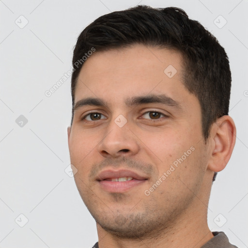 Joyful white young-adult male with short  black hair and brown eyes