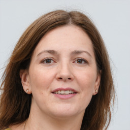 Joyful white adult female with long  brown hair and brown eyes