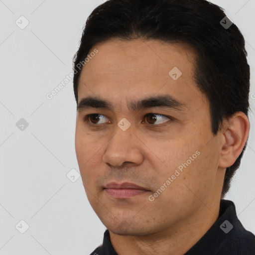 Joyful latino young-adult male with short  black hair and brown eyes