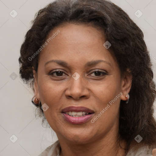 Joyful black adult female with medium  brown hair and brown eyes