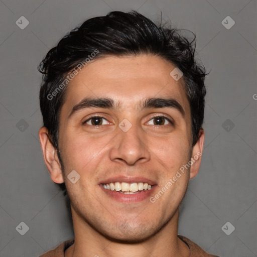 Joyful white young-adult male with short  black hair and brown eyes